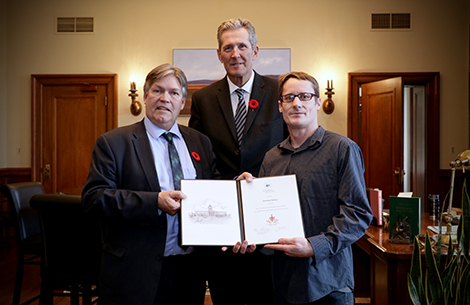 Photo of Honourable Ian Wishart,  Minister of Education and Training; Honourable Brian Pallister, Premier of Manitoba, and Christian Haines