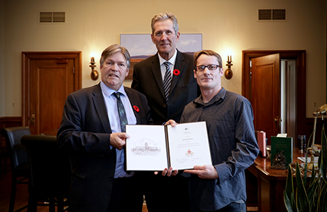 Photo of Honourable Ian Wishart, Minister of Education and Training; Honourable Brian Pallister, Premier of Manitoba, and Christian Haines