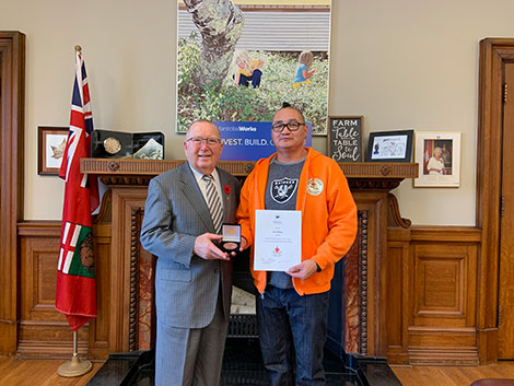 Photo of Honourable Ralph Eichler, Minister of Economic Development and Training; and Elvis MacKay, Manitoba Recipient of the 2019 COF Literacy Award