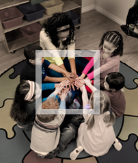 Six children and their teacher join hands in a circle.