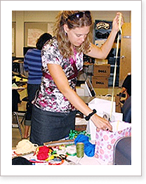 A female teacher is gathering workshop supplies for a professional learning session on student engagement.