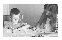 brother and older sister doing homework