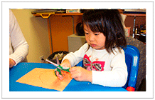 preschool girl using scissor